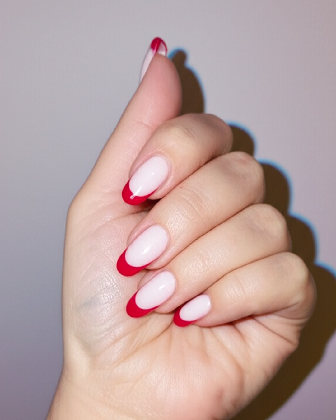 ruby almond French Tip Nails - medium glossy ruby french tip nails with milky-white base, almond shape, medium length, glossy finish