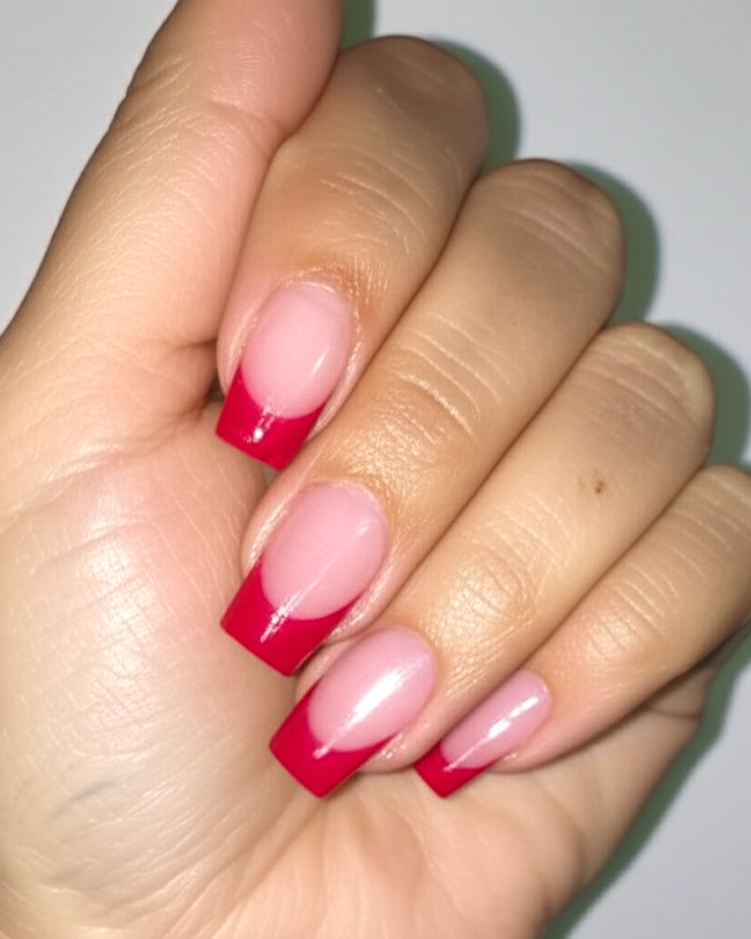 ruby coffin French Tip Nails - medium glossy ruby french tip nails with natural base, coffin shape, medium length, glossy finish