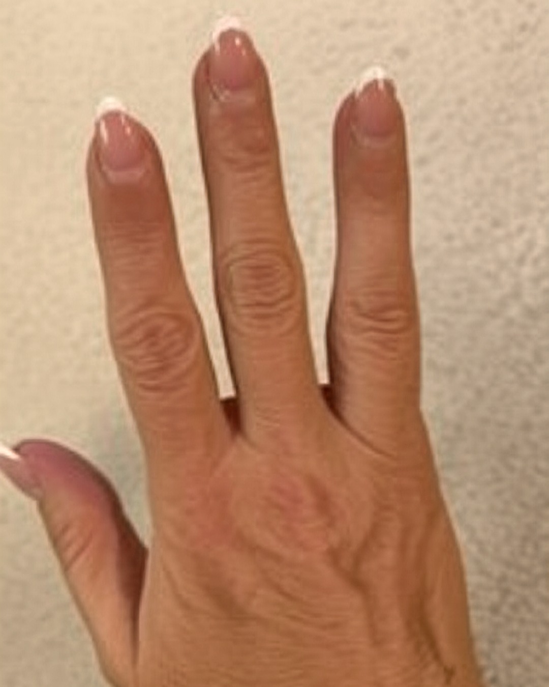 white french tip nails with natural base, almond shape, medium length, glossy finish