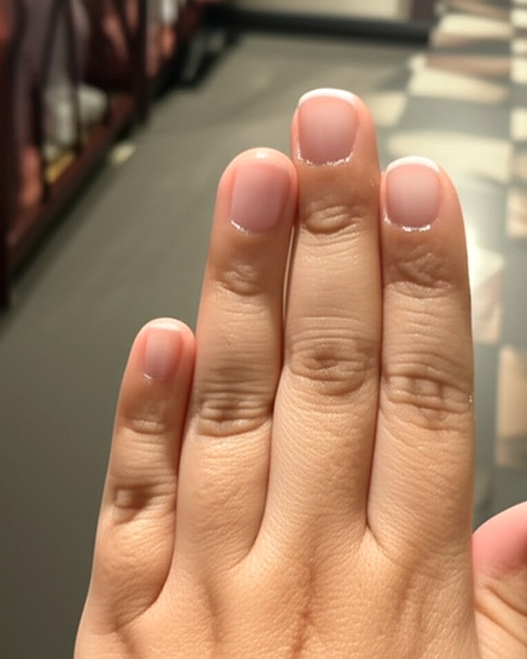 white french tip nails with natural base, almond shape, medium length, glossy finish