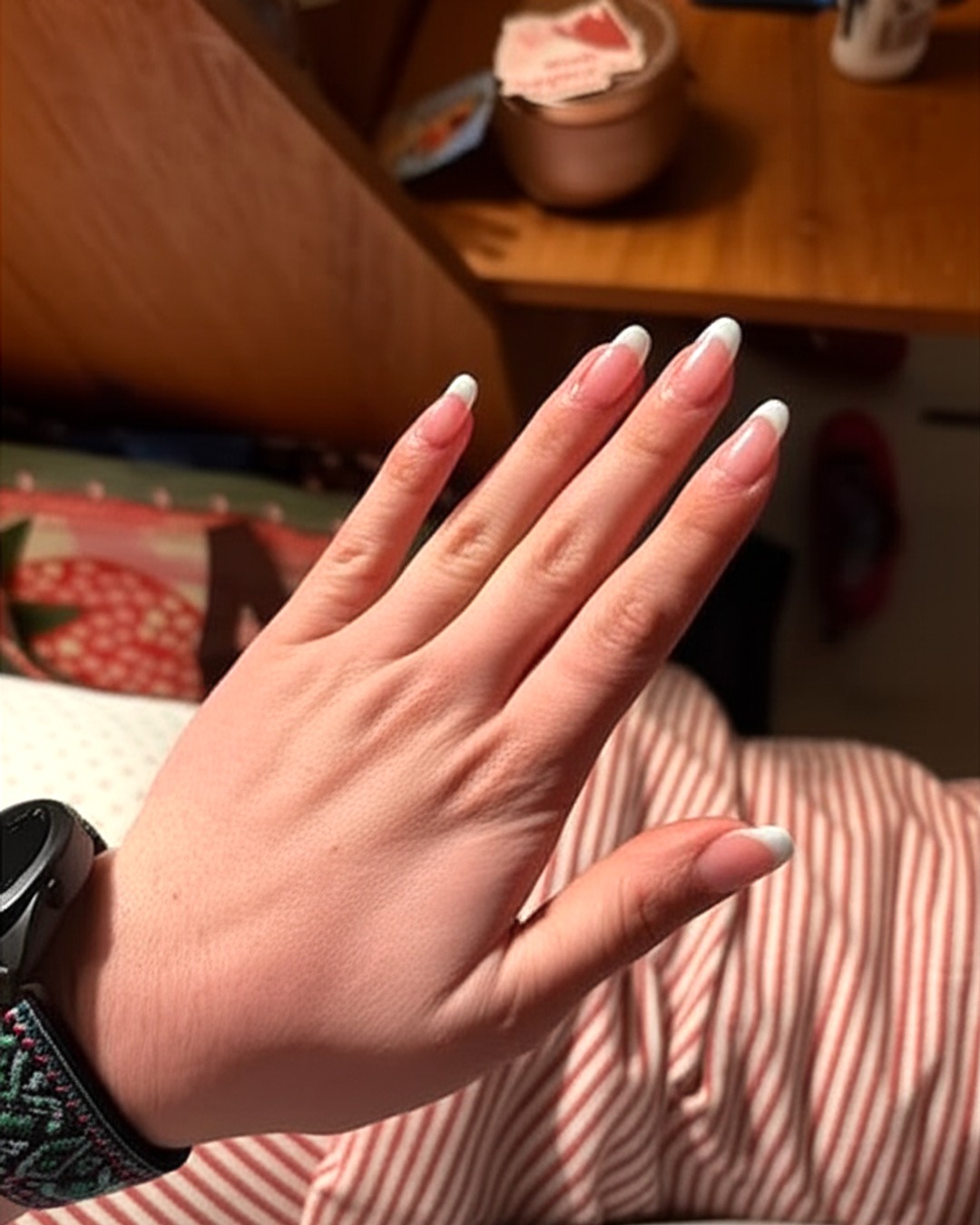 white french tip nails with clear base, almond shape, medium length, glossy finish