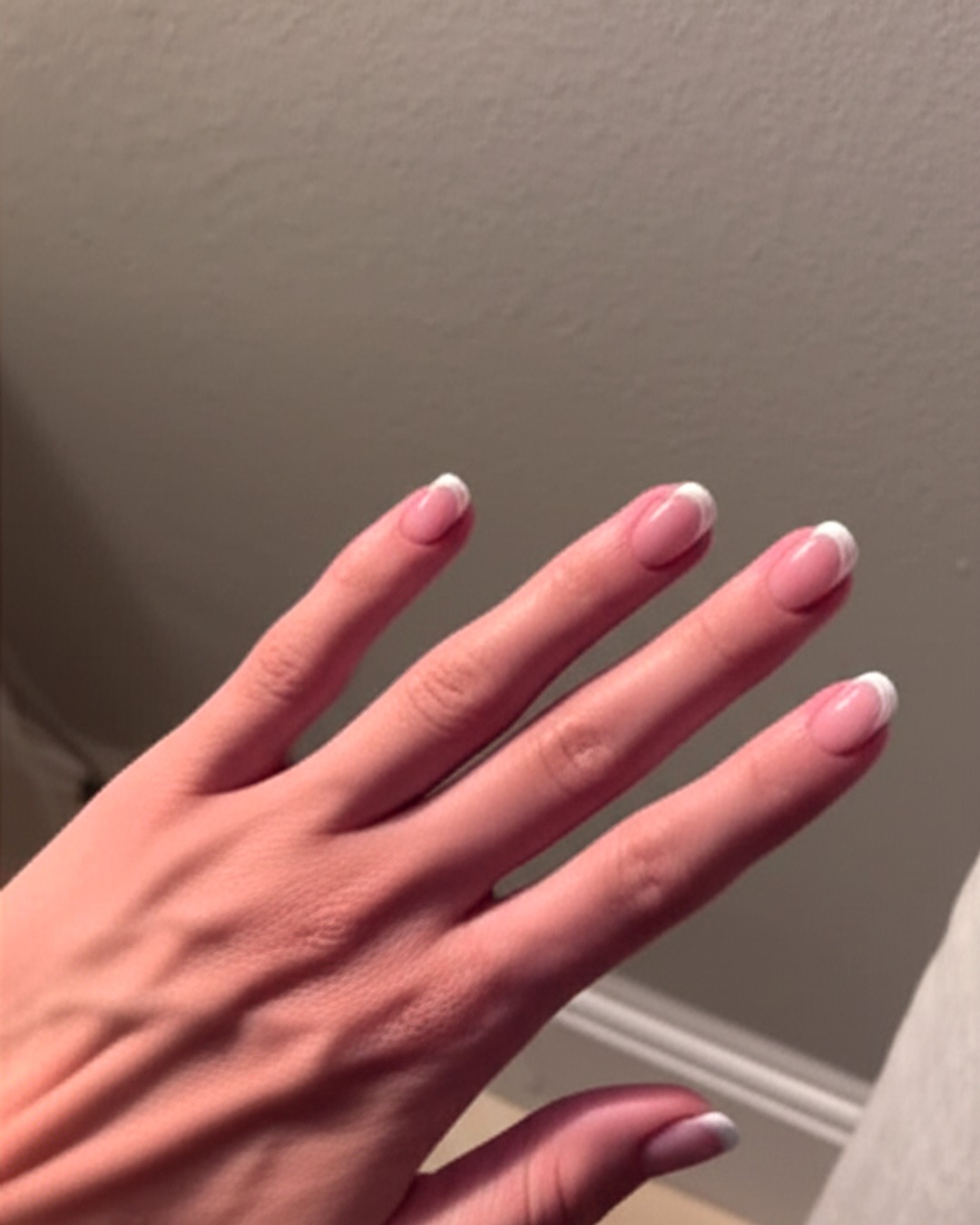 white french tip nails with natural base, almond shape, short length, glossy finish